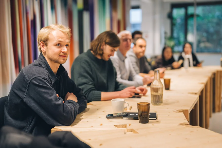AI-Blox team members around the table in the office